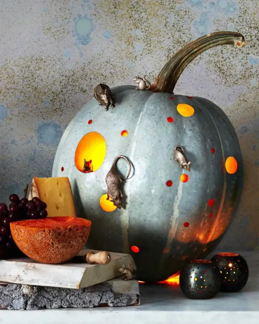 Whimsical pumpkin carving with glowing holes and mouse figurines, perfect for easy but awesome Halloween decoration ideas for kids and beginners.