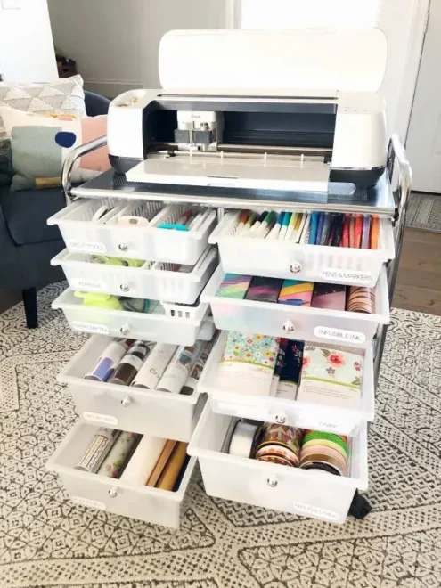 A compact, organized craft room showcasing DIY storage solutions with a pegboard wall and neatly arranged shelves.